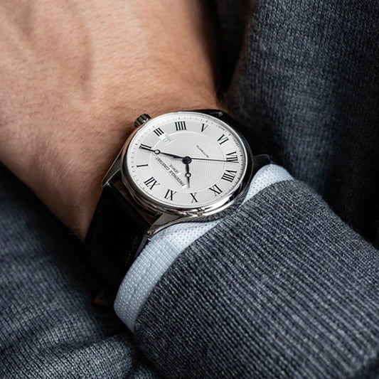 Classic men's analog wrist watch featuring a white Roman dial and black leather strap